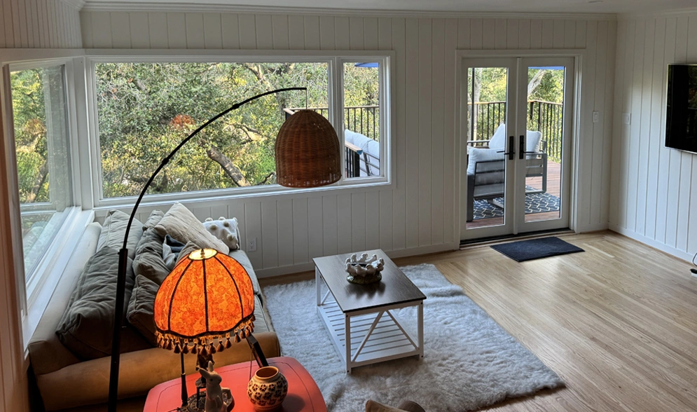 Bright living room with large windows and natural decor